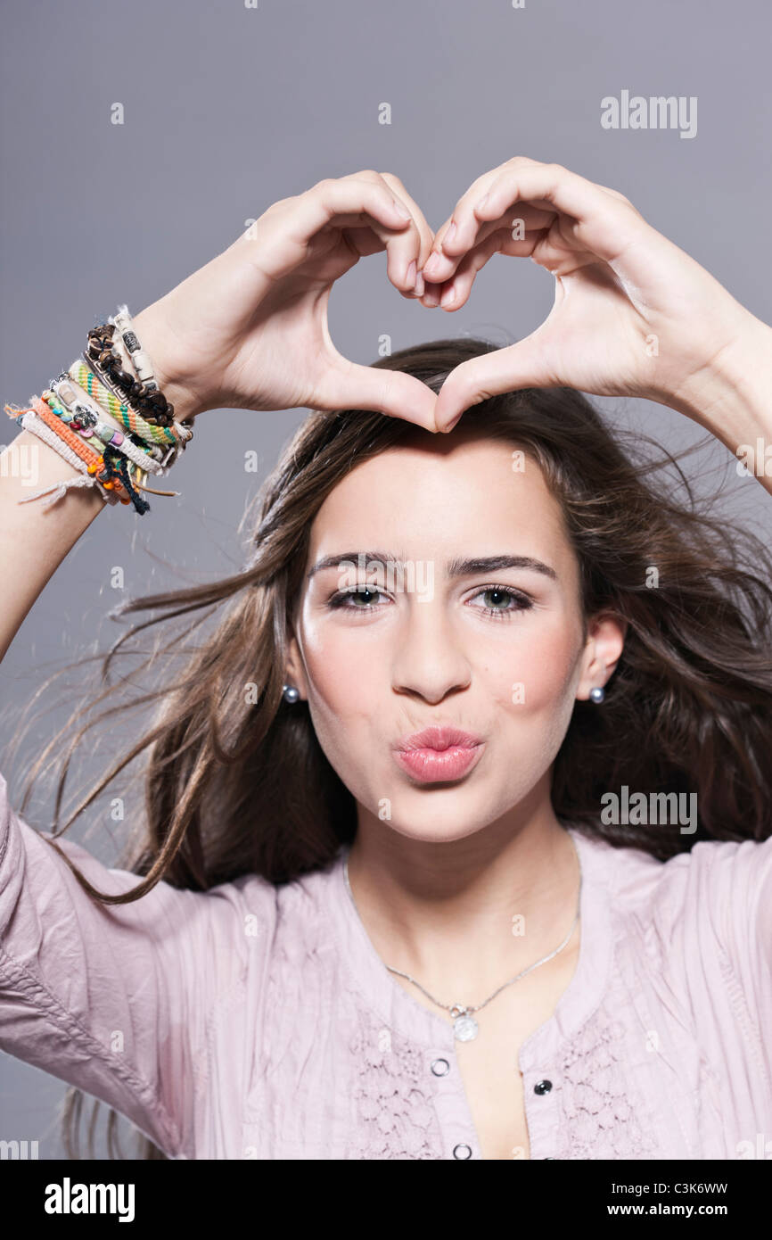 Girl makes a heart with her hands, portrait Stock Photo - Alamy
