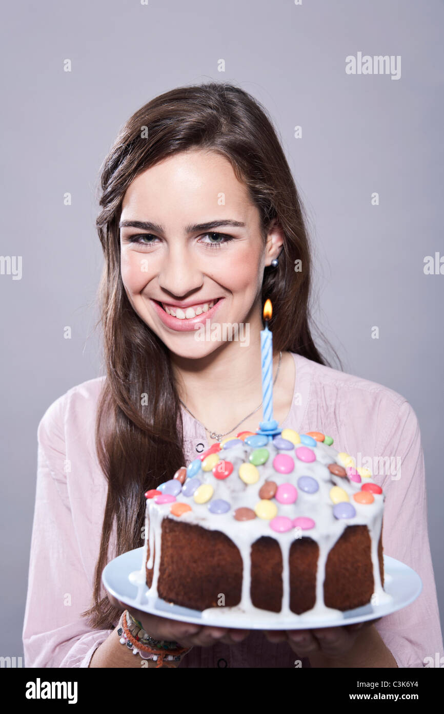 Girl holding cake, smiling, portrait Stock Photo Alamy