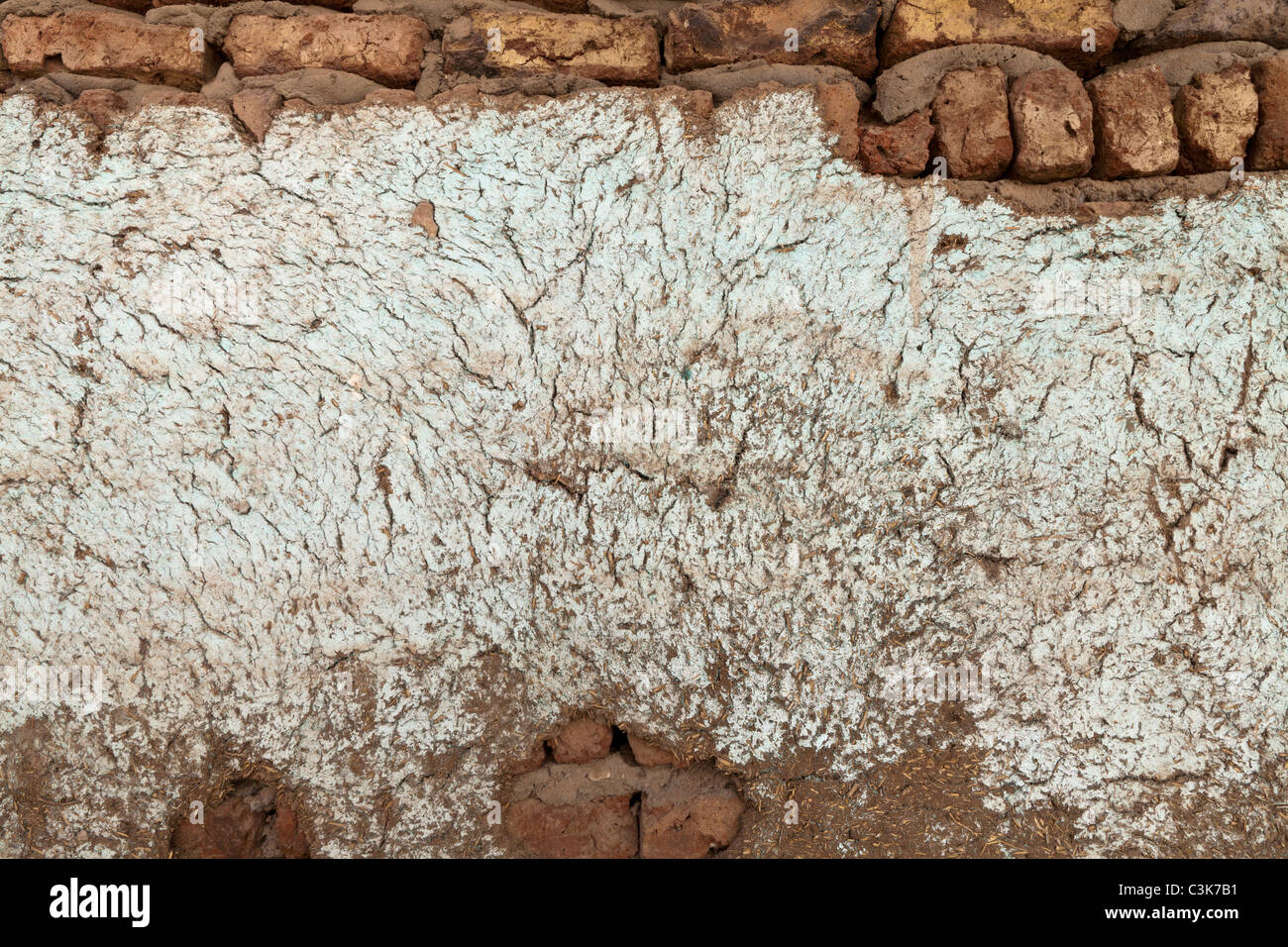 Close up area of mud brick wall showing approximately nine courses, with large cracked rendered area in middle, Egypt, Africa Stock Photo