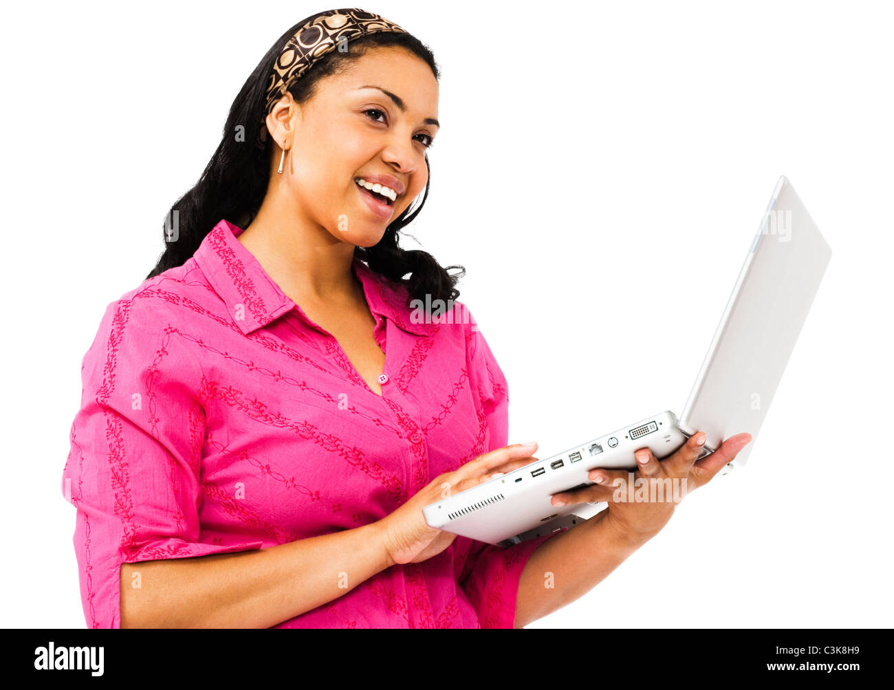Smiling young woman using a laptop isolated over white Stock Photo - Alamy