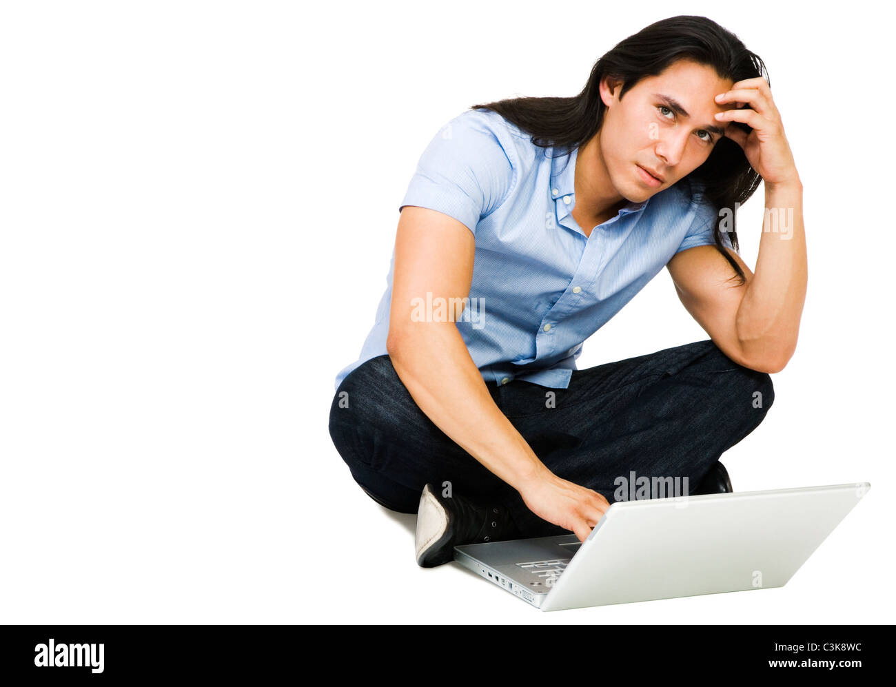 Latin American man using a laptop isolated over white Stock Photo
