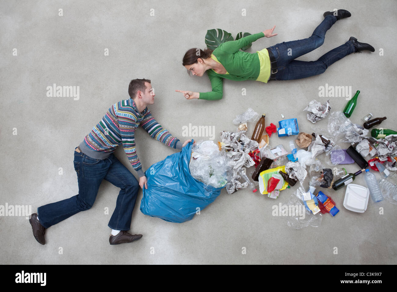 Woman pointing towards man throwing garbage Stock Photo Alamy