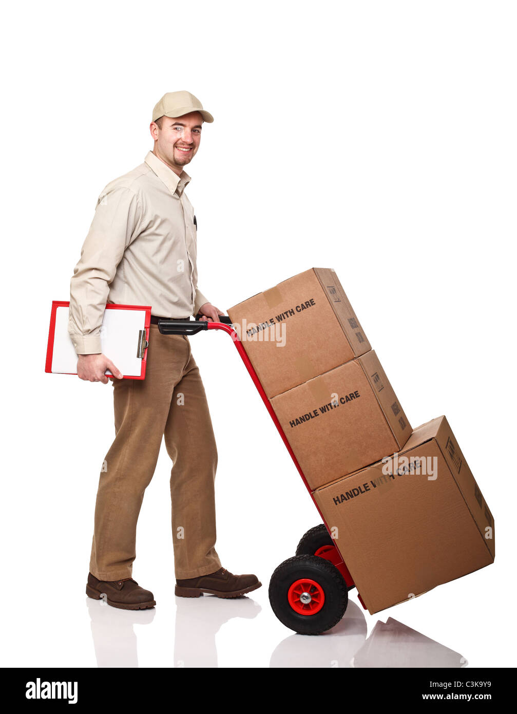 smiling delivery man with red handtruck on white background Stock Photo