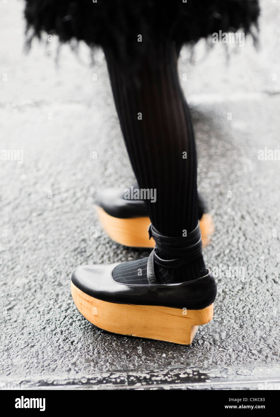 Low section of woman wearing wooden wedge shoes Stock Photo