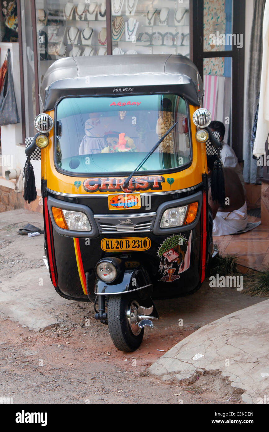 A motorised rickshaw decorated with christ outside a hotel in Kovalm Kerala India Stock Photo
