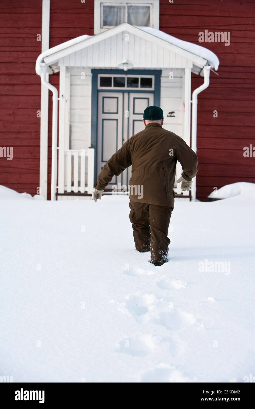 A man walking in the snow, Sweden. Stock Photo