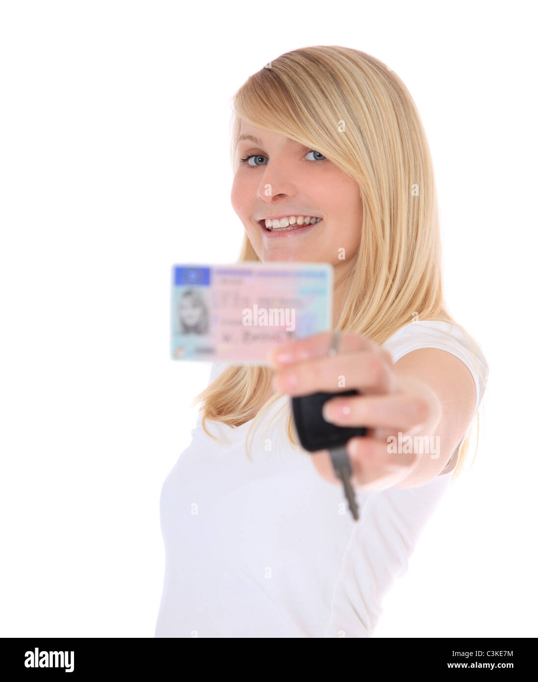 Attractive young woman proudly showing her european driver license. All on white background. Stock Photo