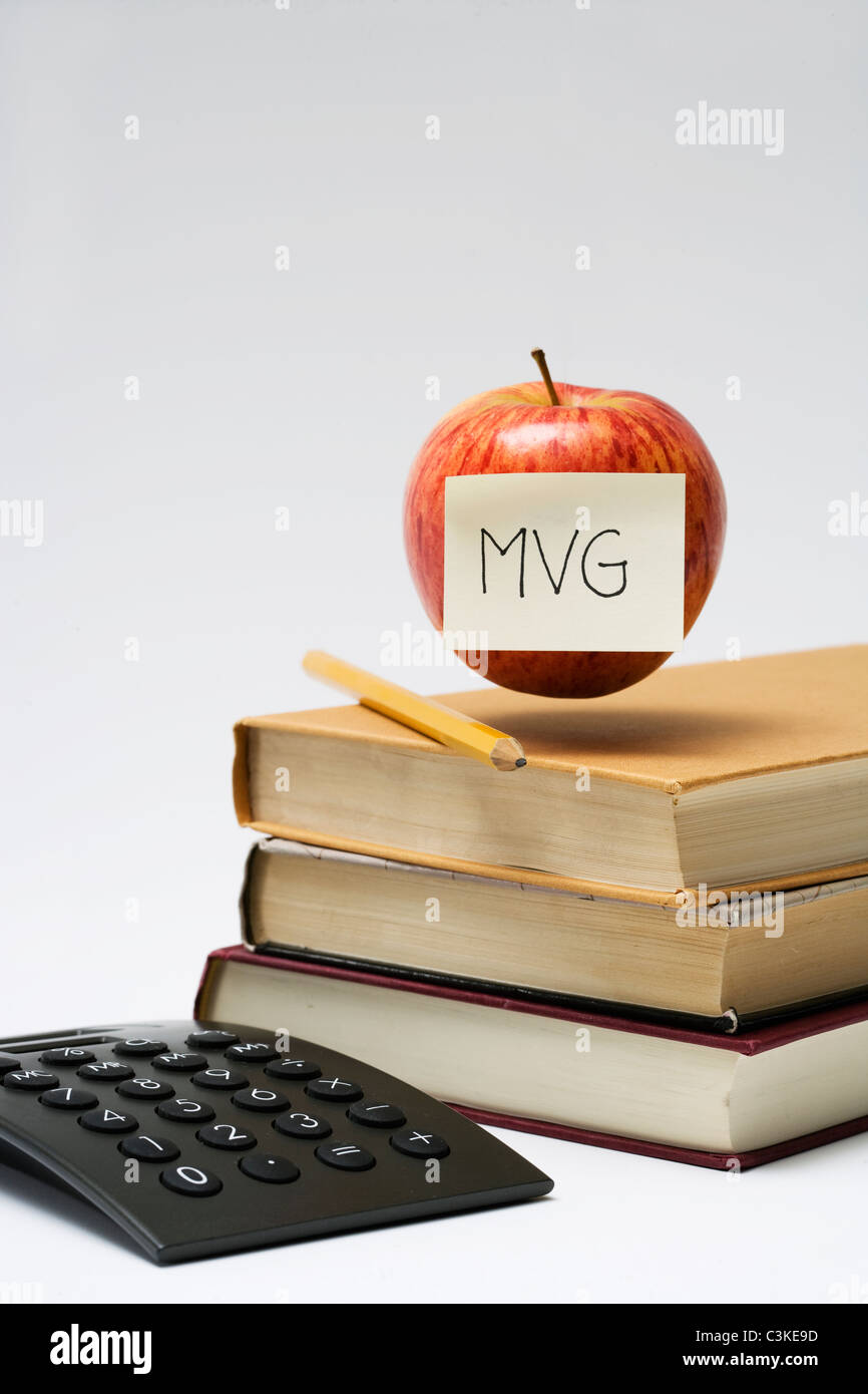 An apple on a stack of books, close-up. Stock Photo