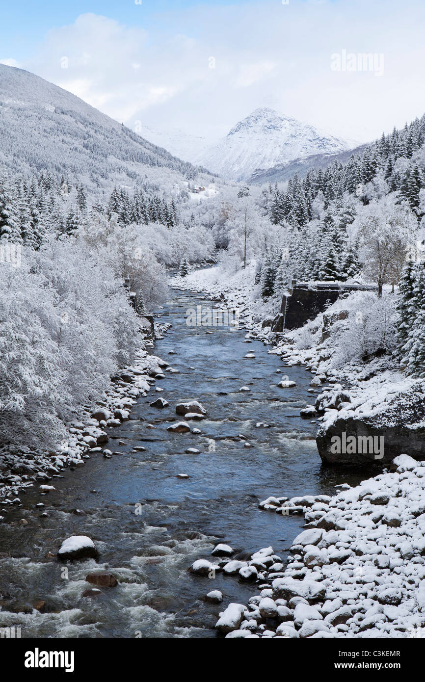 View of stream and snow covered trees, Stordal, Norway. Stock Photo