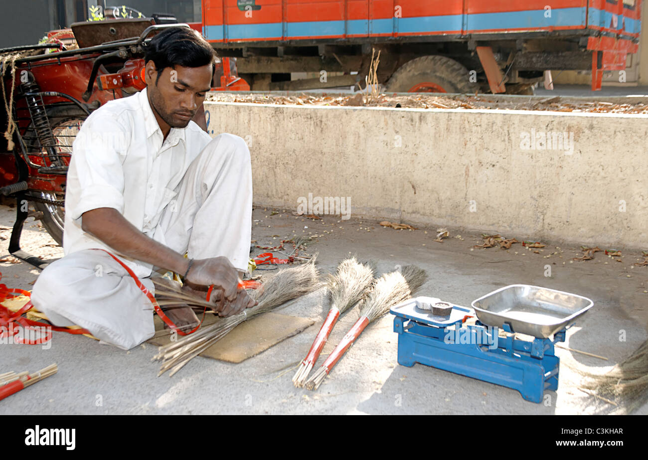 mobile tradesman traveling village to village making brushes sweeper Jaaroo in Gujarat india Stock Photo
