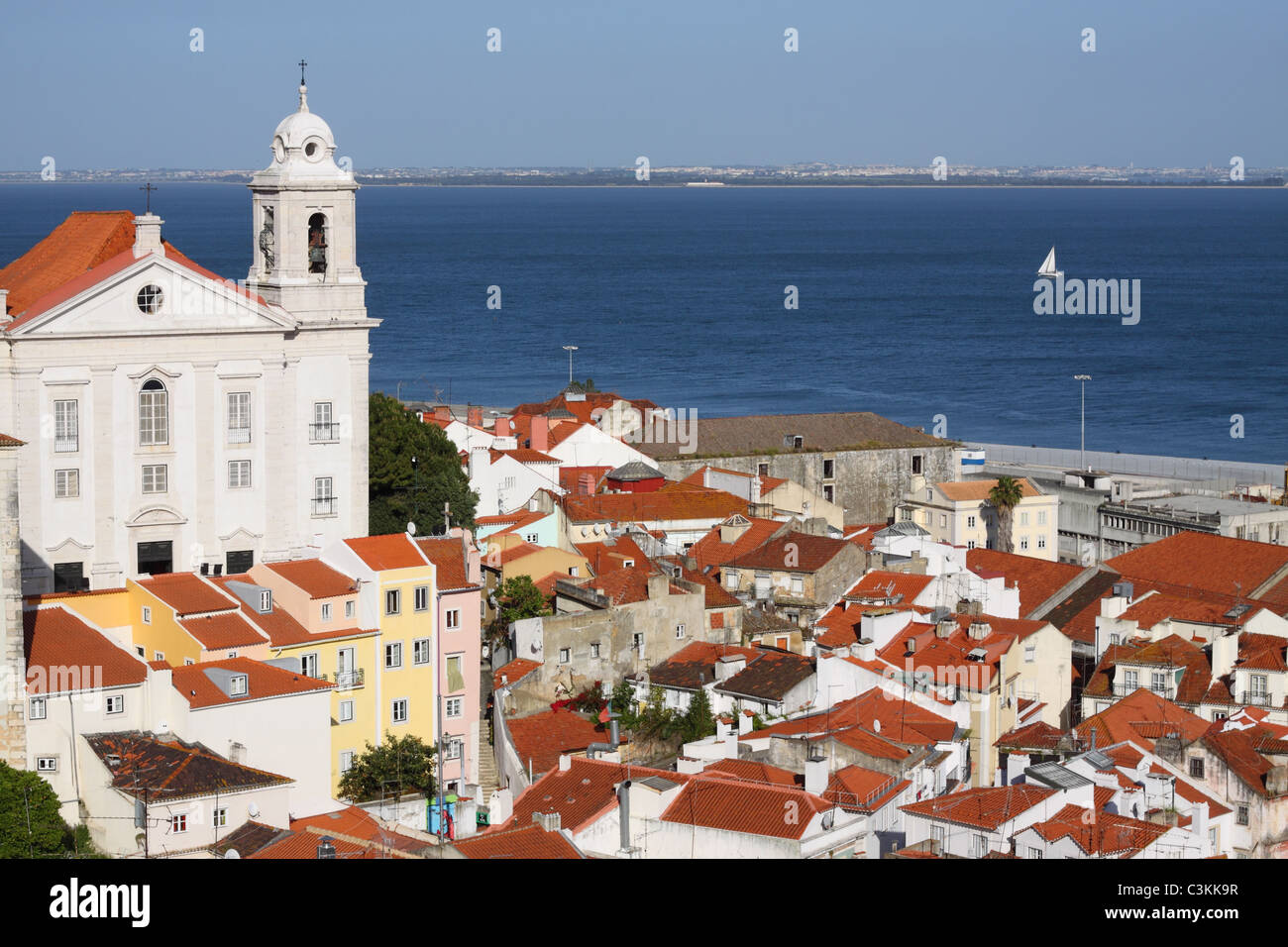 Lisbon Portugal view across the rooftops of Alfama and the Santo Estevao church Stock Photo