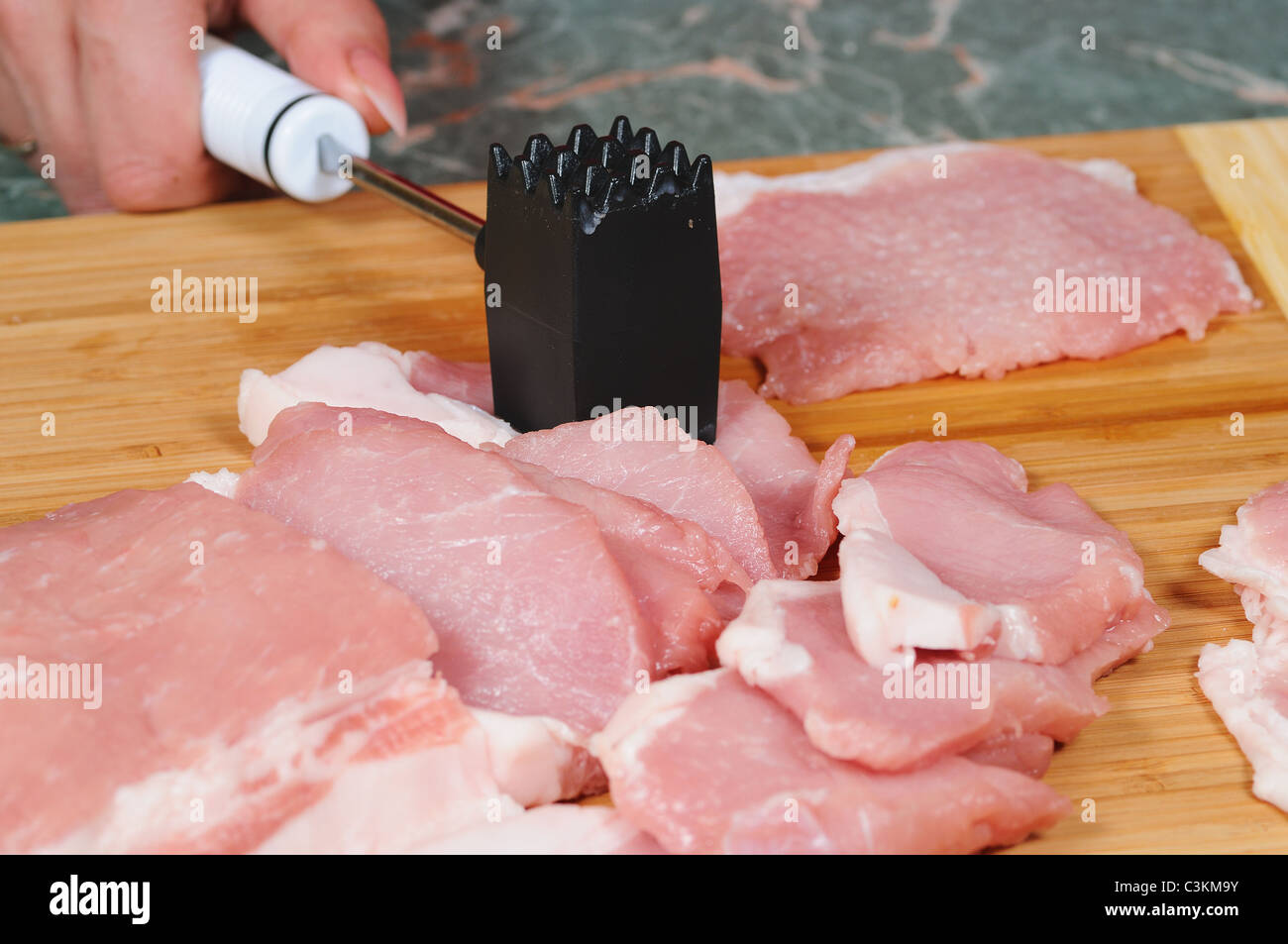 The cook prepares a chop from pork Stock Photo Alamy