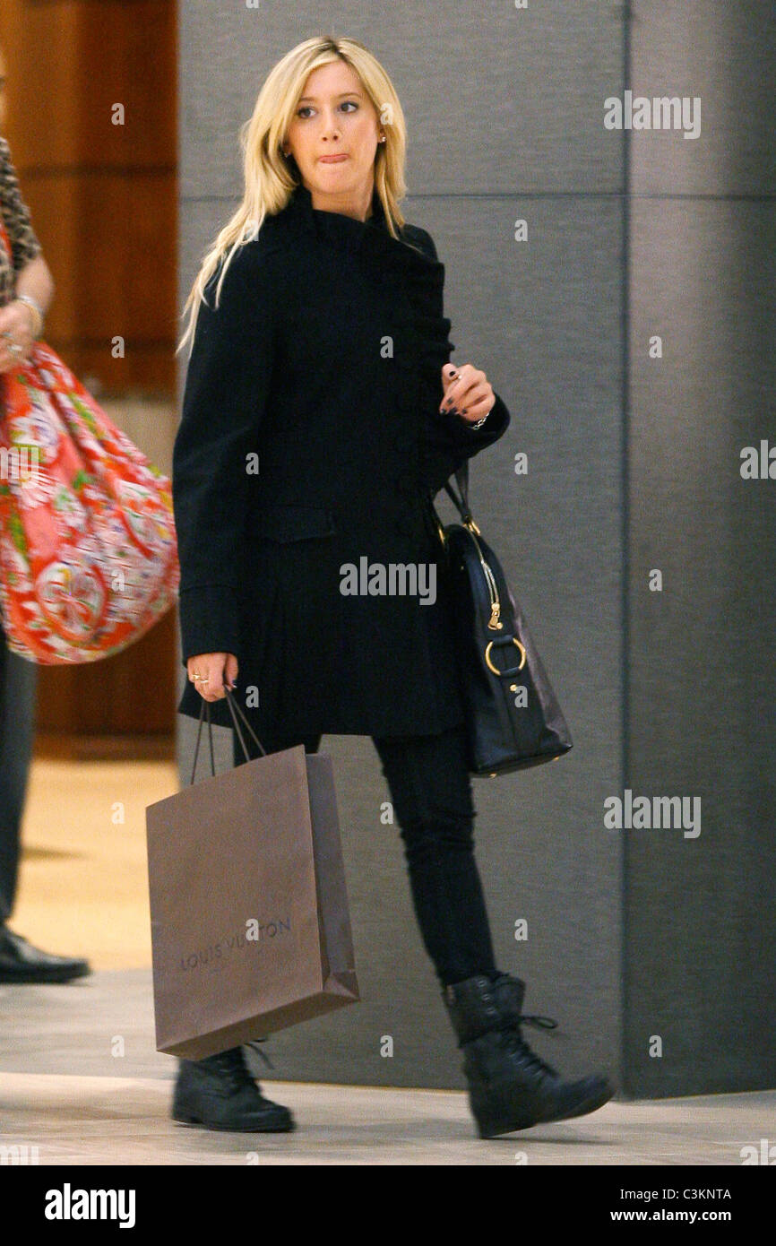Ashley Tisdale carrying a Louis Vuitton shopping bag while out