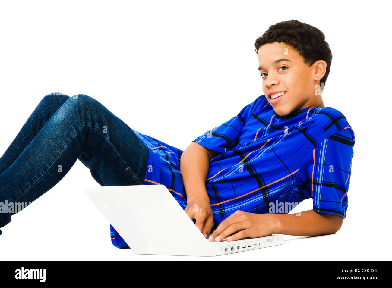 Teenage boy reclining and using a laptop isolated over white Stock ...
