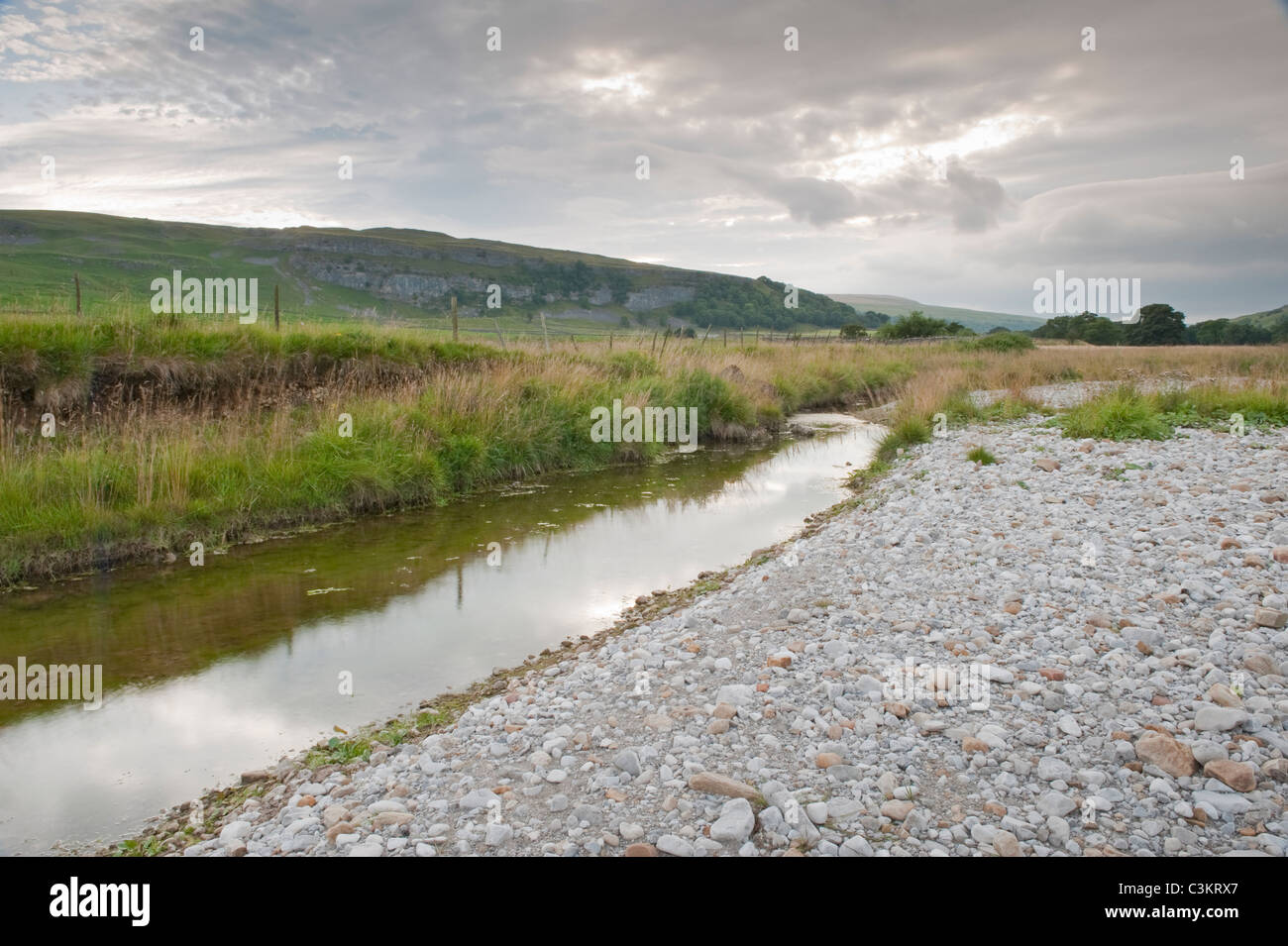 River Skirfare in flat valley (shallow water, drought, dry rocks, limestone environment, exposed riverbed) - Littondale, Yorkshire Dales, England, UK. Stock Photo