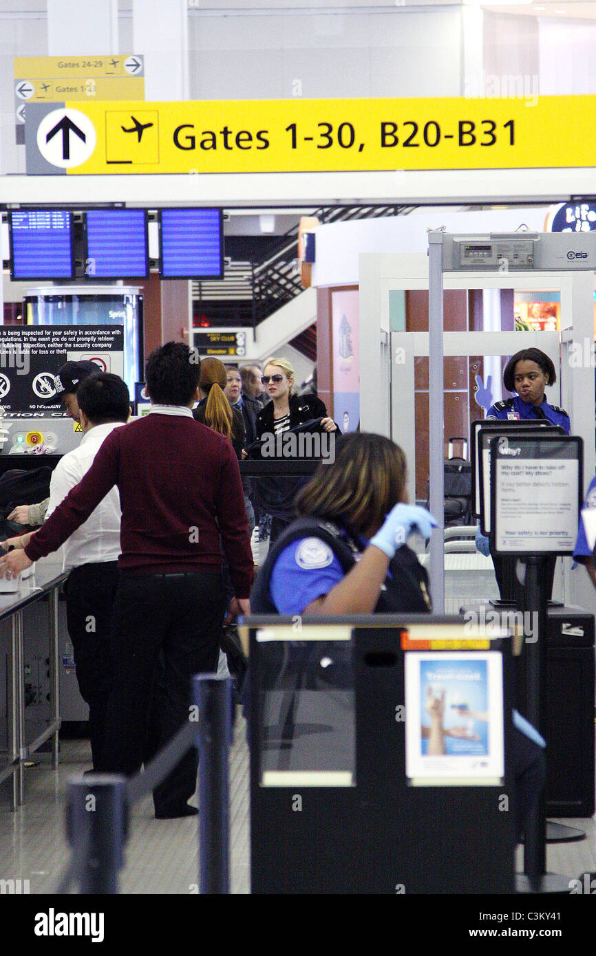 Lindsay Lohan going through security at JFK airport to catch a flight