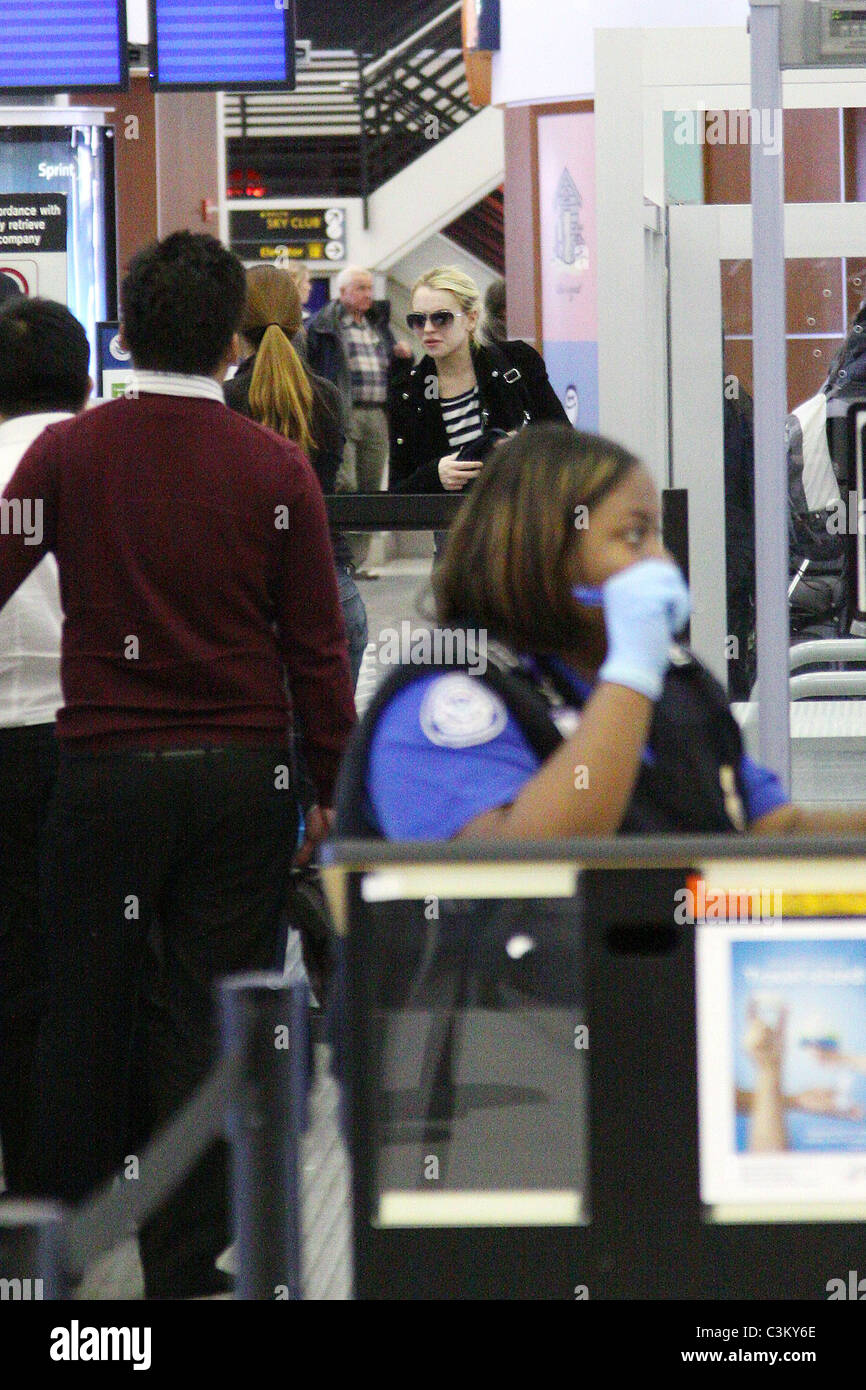 Lindsay Lohan going through security at JFK airport to catch a flight