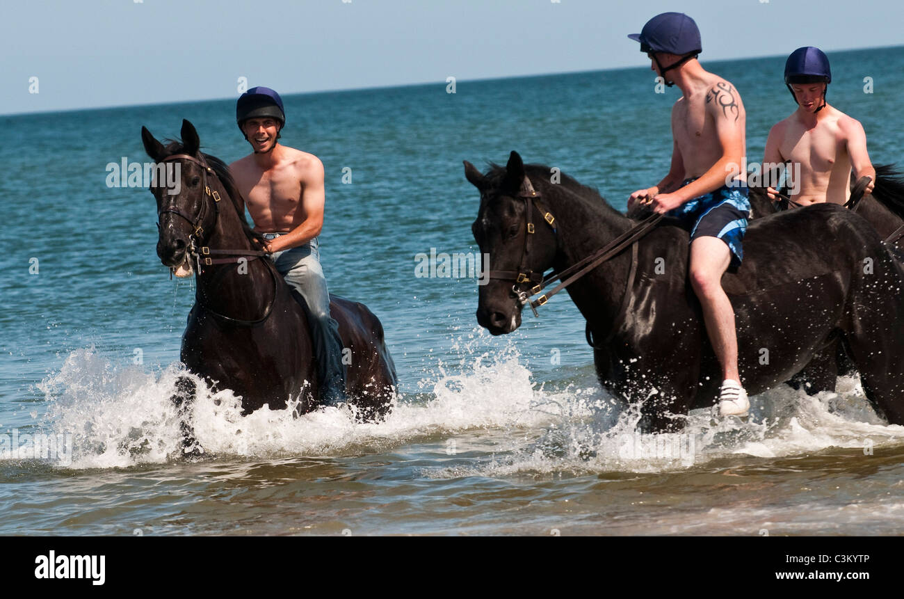 Members of the Blues and Royals of the Household Cavalry at Holkham Beach, Norfolk, UK Stock Photo