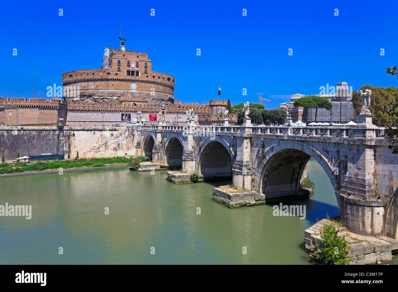 View of famous Sant Angelo Castle and Bridge across river Tiber in Rome, Italy. Stock Photo