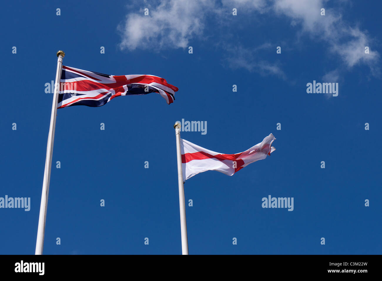 Two flags flying in the wind one Union Flag and one English Flag Stock