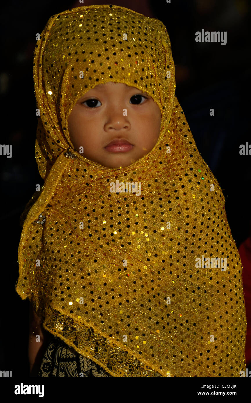 little muslim girl in traditional dress , street festival, bangkok, thailand Stock Photo