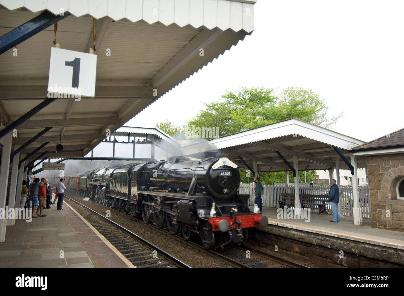 Double headed steam locomotives 'Black Five' 45305 and 'Brittania' 70013 'Oliver Cromwell' speed through St.Erth station. Stock Photo