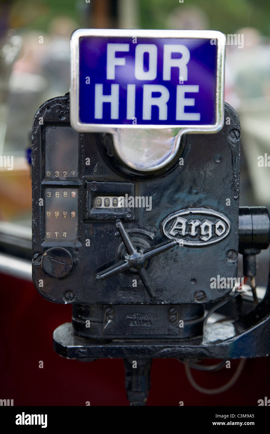 The Argo brand meter and 'For Hire' sign on a 'vintage' 1934 classic old  British taxi cab / car Stock Photo - Alamy