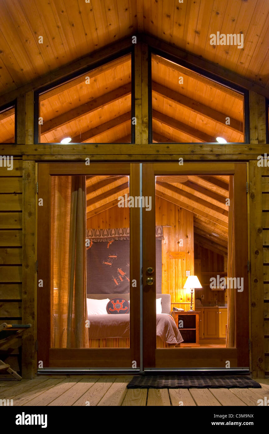 Guest bed in rustic luxury in cedar wood cabin, El Capitan Canyon Resort, near Santa Barbara, California Stock Photo