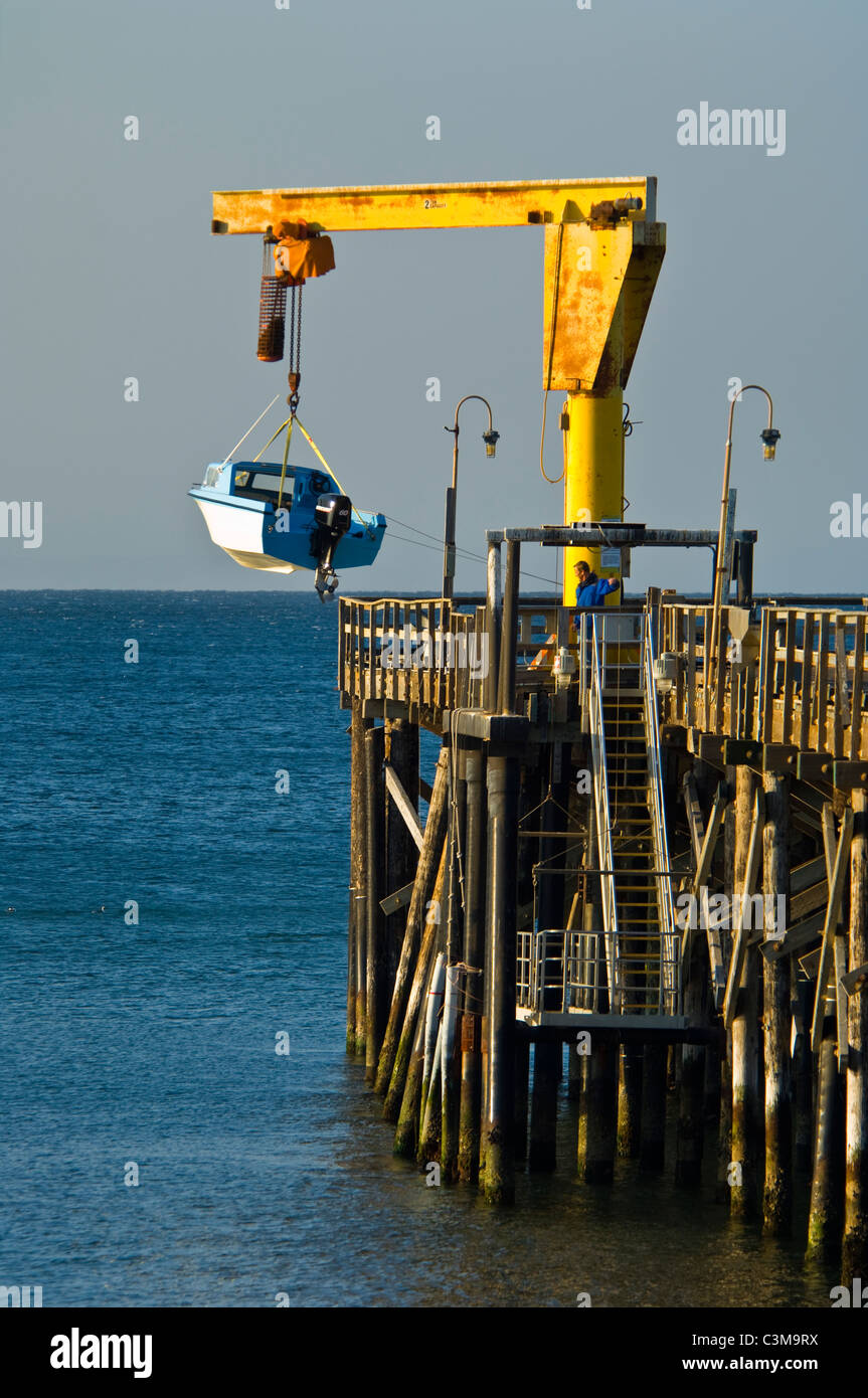 Launching a small motor boat from pier at Gaviota Beach State Park, near Santa Barbara, California Stock Photo