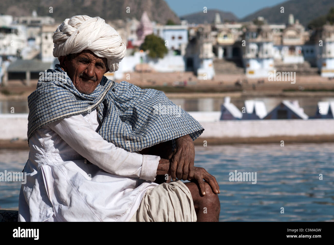 Indian man posing on the banks of Pushkar's lake in India. Stock Photo