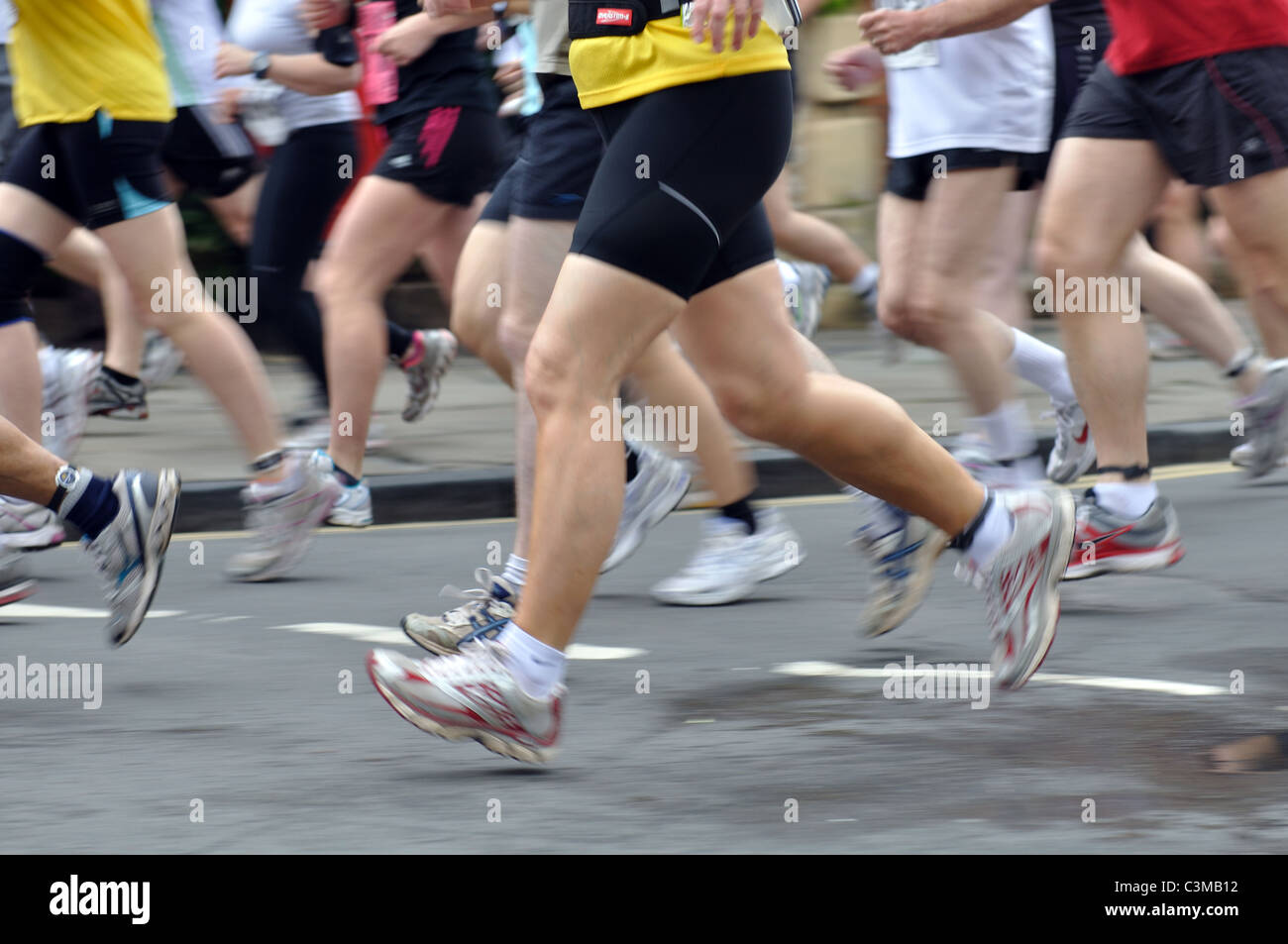 Legs of runners in the Shakespeare Marathon and Half Marathon race Stock Photo