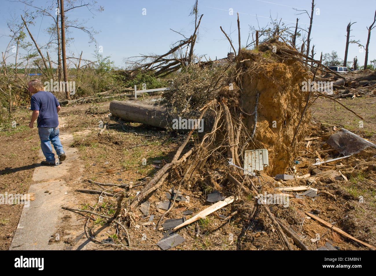 Man walks through his neighborhood in Pleasant Grove, Alabama, observing wreckage from tornado, May 2011. Stock Photo