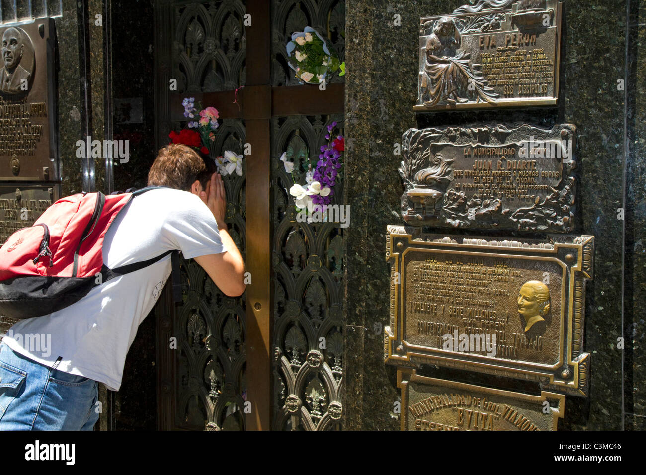 Tourist taking a photo of the bronze plaque marking Eva Peron mausoleum in La Recoleta Cemetery, Buenos Aires, Argentina. Stock Photo