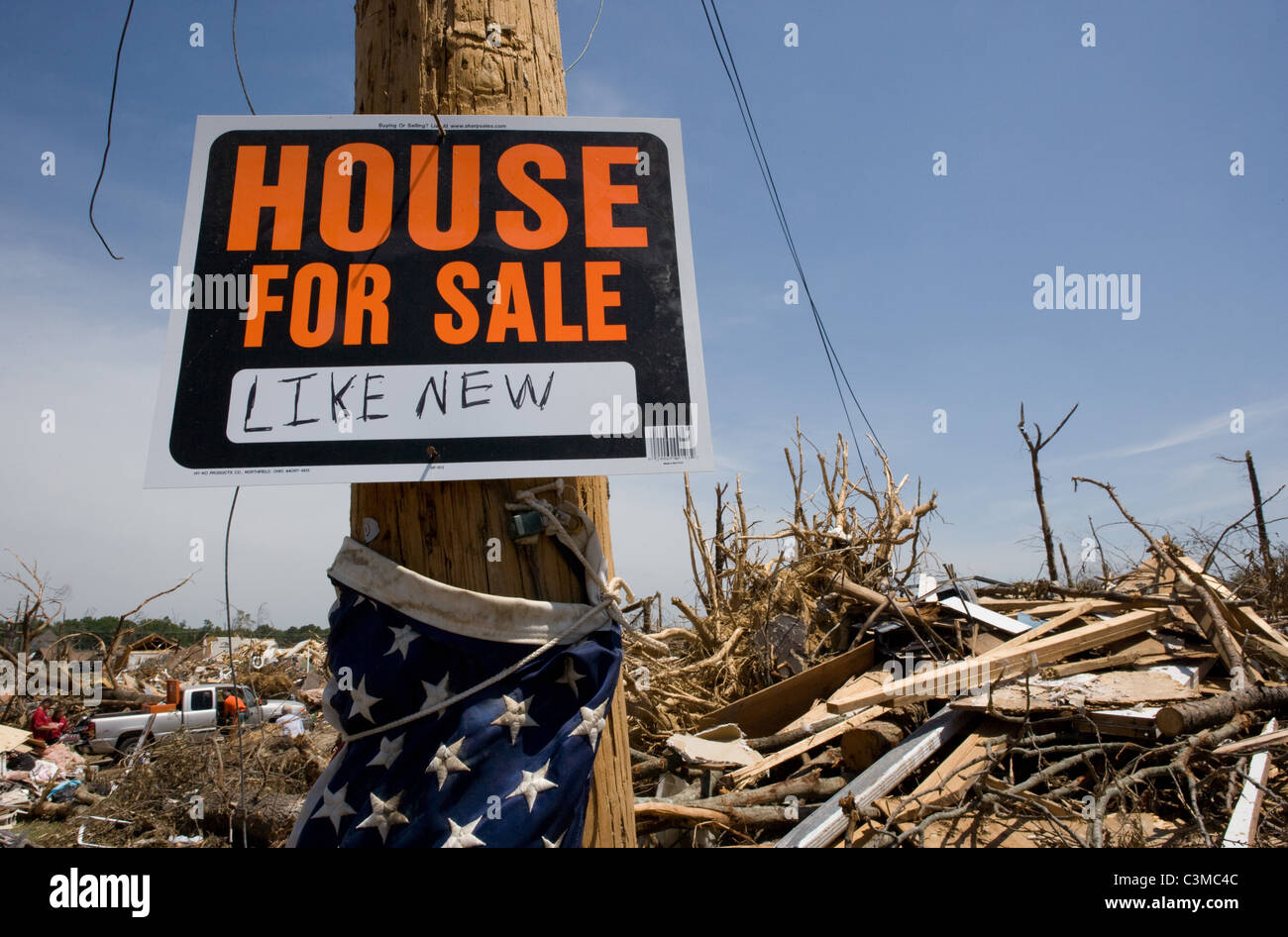 An ironic, humorous sign, House for Sale Like New after tornado crushed a home in Pleasant Grove, Alabama Stock Photo