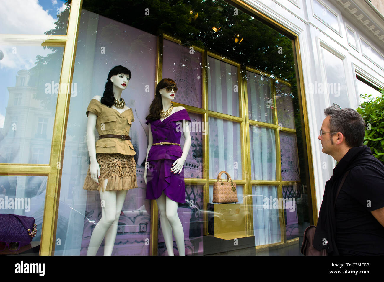 Man looking at Mannequins at Dior boutique Paris France Stock Photo