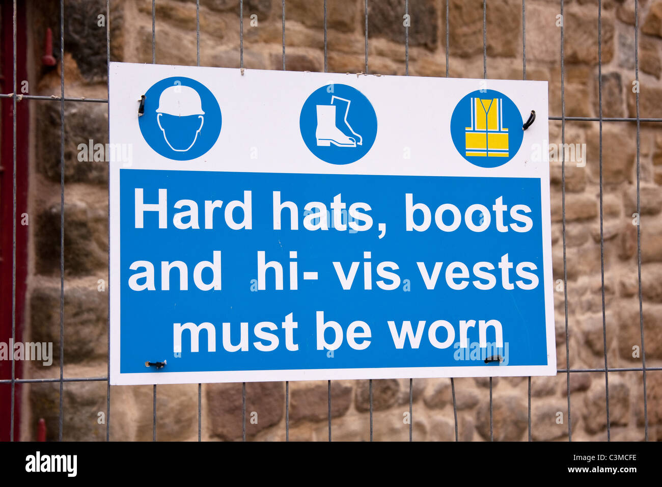 Hard hat zone sign on protective fence at building site Stock Photo Alamy