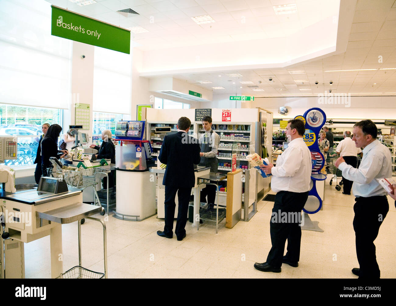 A queue of men at the checkout till, Waitrose supermarket Newmarket Suffolk UK Stock Photo
