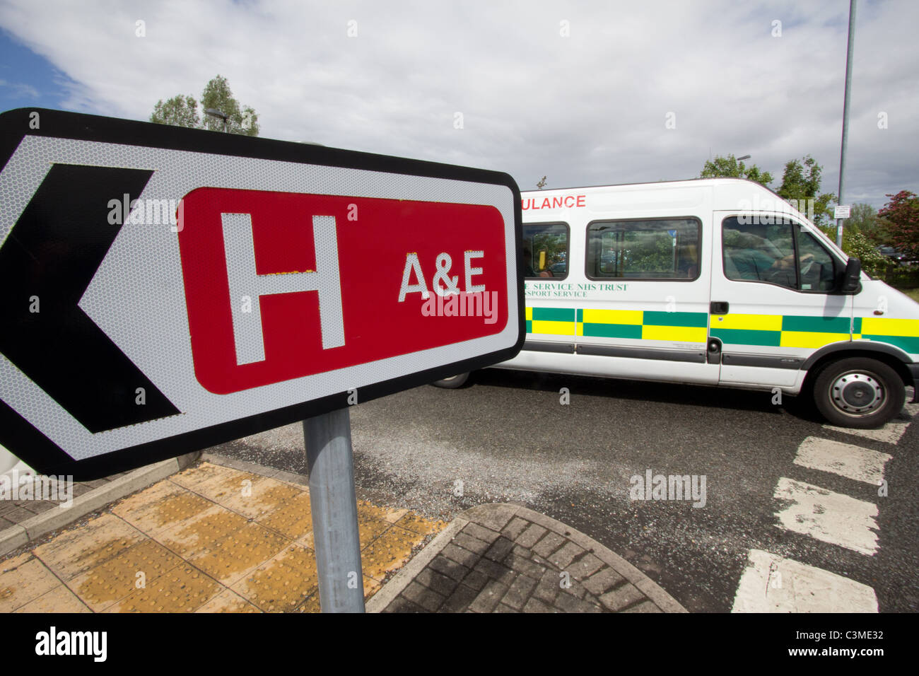 Welsh hospital A&E sign and white ambulance at Ysbyty Glan Clwyd, north Wales Stock Photo