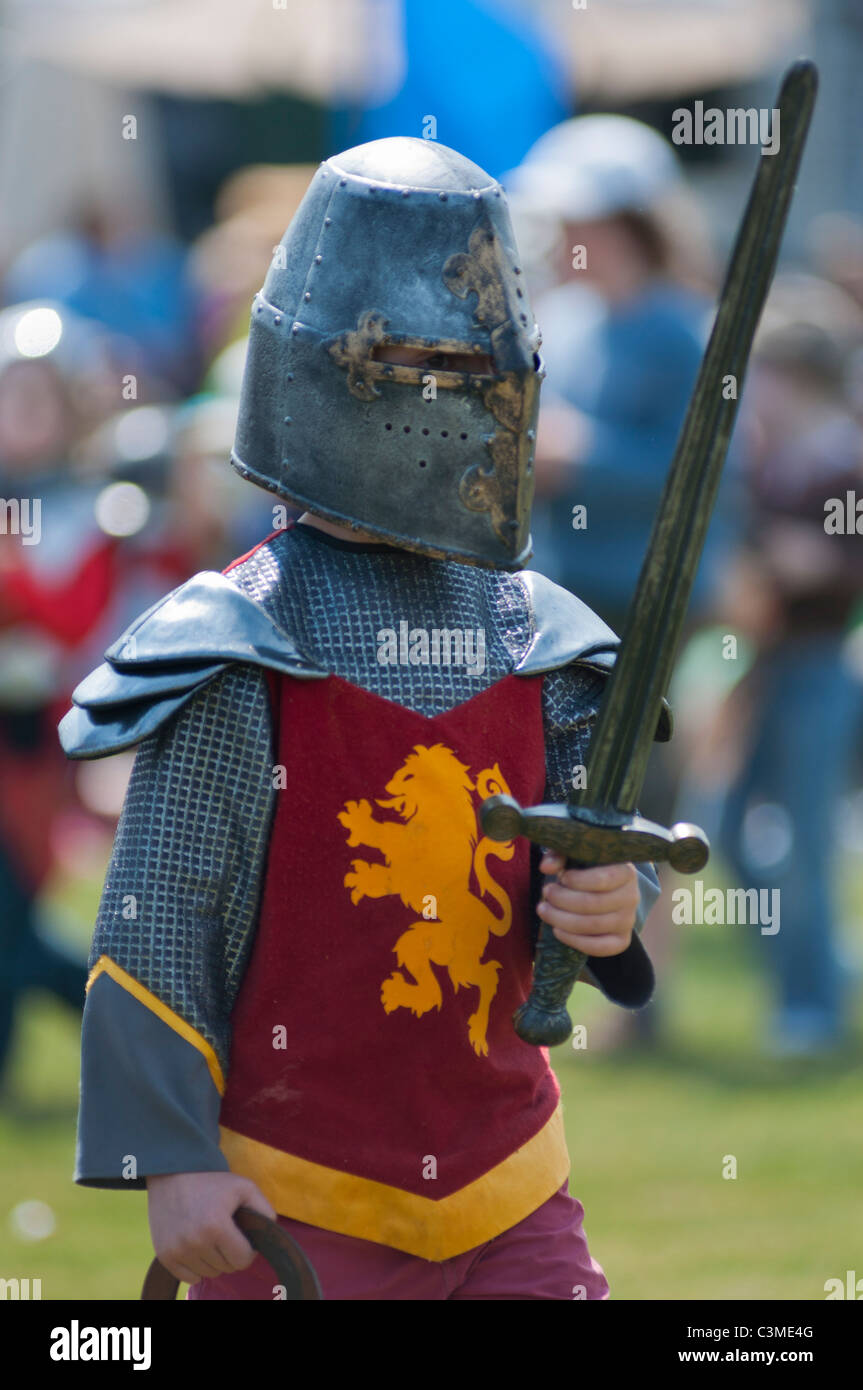 A little boy dressed in medieval armour at a jousting event at Blenheim palace, Oxfordshire. UK Stock Photo