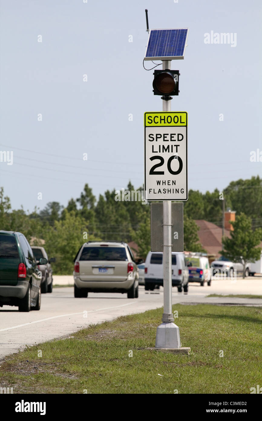 School zone speed limit sign on busy street Stock Photo