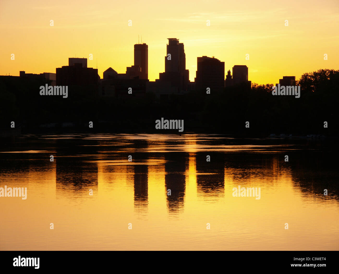 Sunset silhouette of the University of MN west bank campus and Minneapolis skyline from the Mississippi River catwalk at I-94. Stock Photo