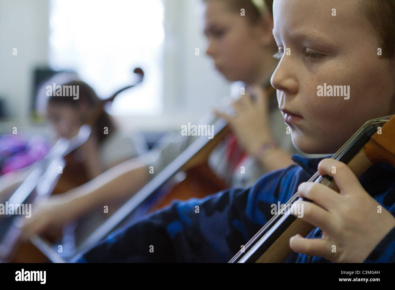 Children playing music orchestra hires stock photography and images