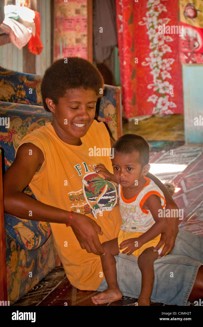 Fijian mother and baby in their home, Naveyago Village in Sgatoka Valley, Coral Coast, Sigatoka