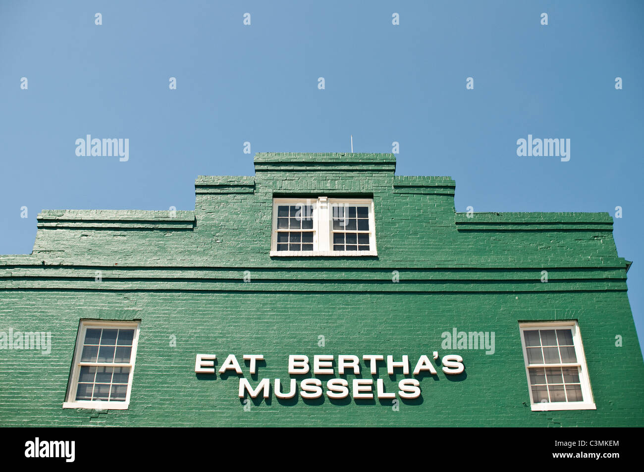 A landmark sign in Baltimore, Maryland, telling people to Eat Bertha's Mussels at Bertha's Restaurant and Bar in Fells Point. Stock Photo