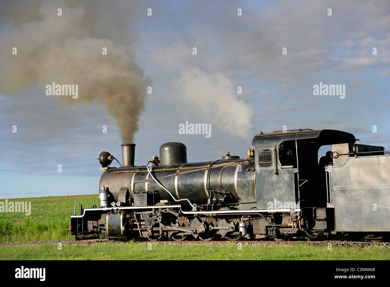 Vintage steam locomotive with billowing smoke and steam Stock Photo