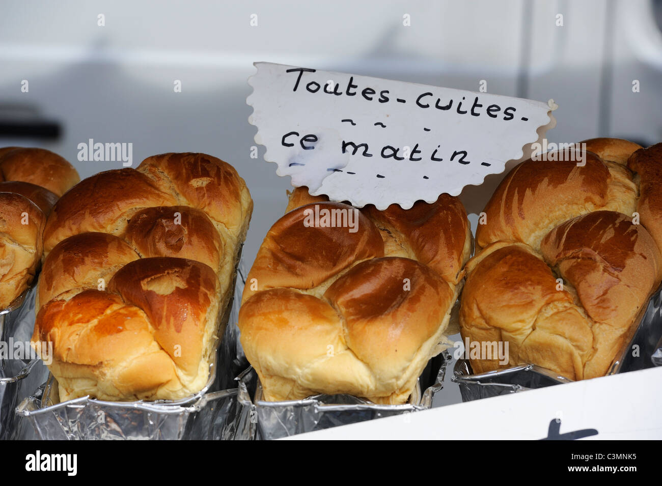 Stock photo of loaves of Brioche for sale on a french market stall