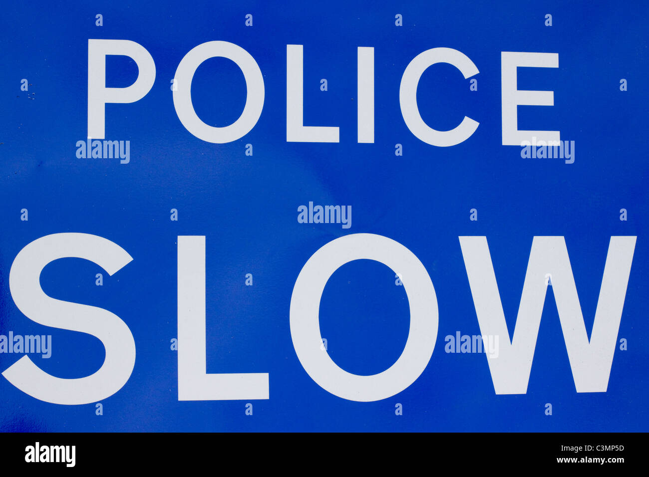 Police Slow Sign on the road side Stock Photo