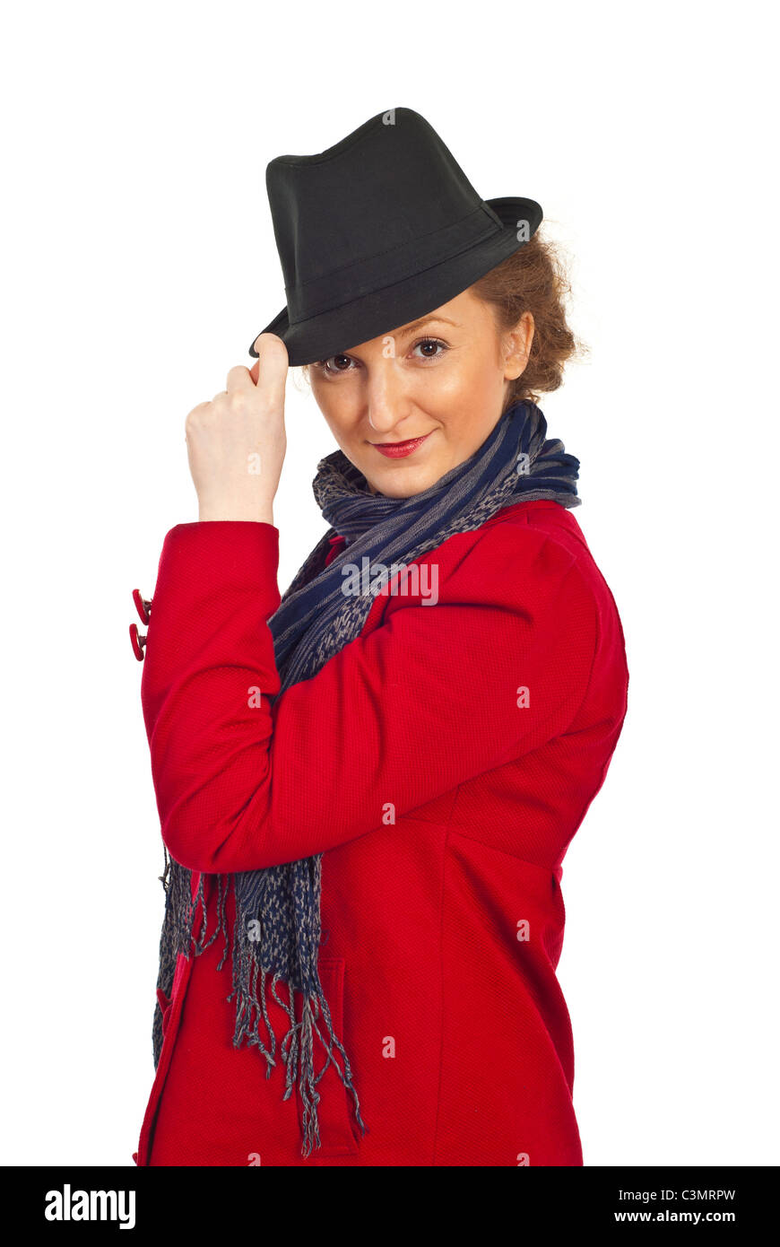 Attractive redhead model woman wearing red jacket and holding black hat