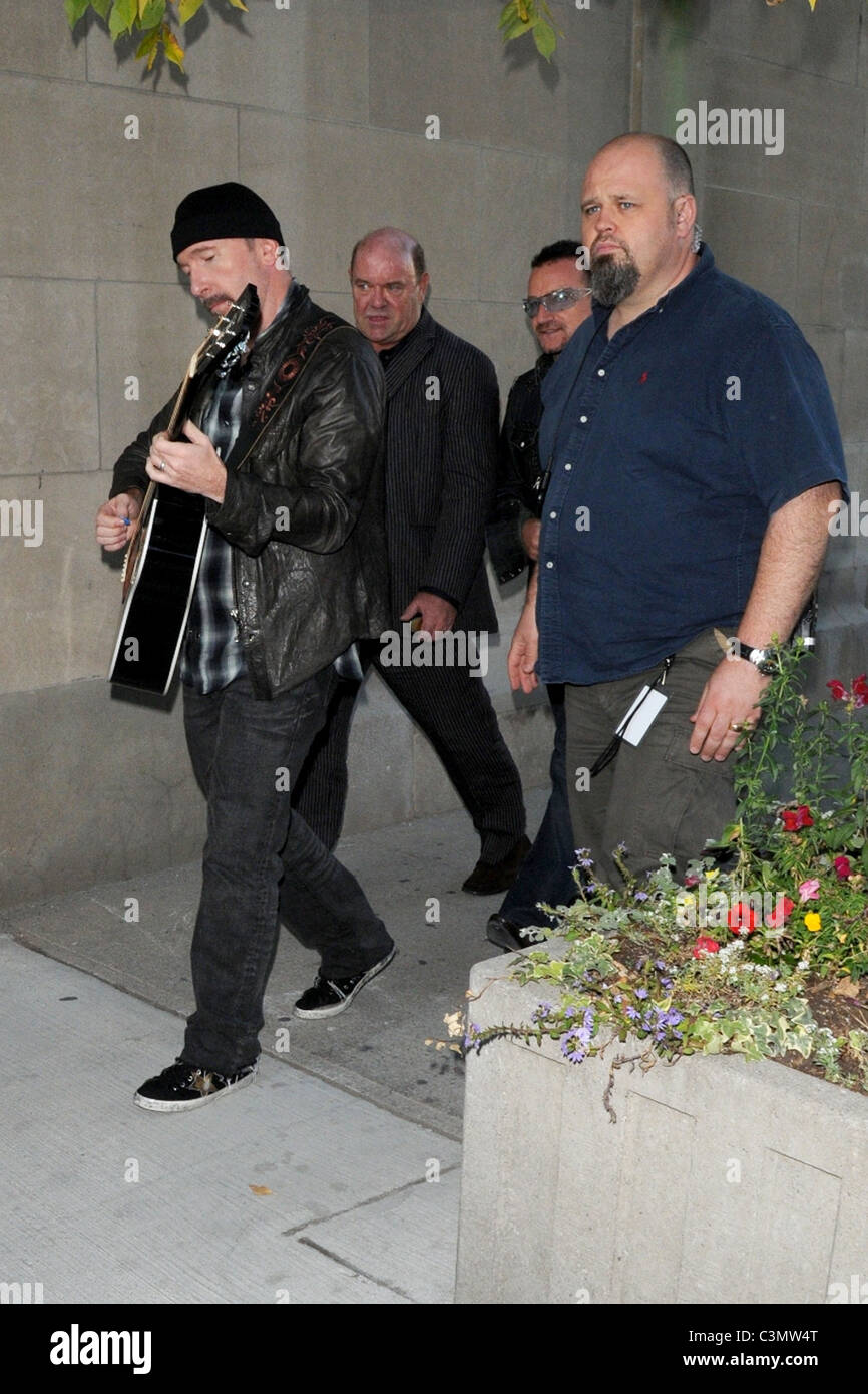 The Edge strumming his guitar and Bono band members of U2 leaving MTV studios at the Masonic Temple Toronto, Canada - 15.09.09 Stock Photo