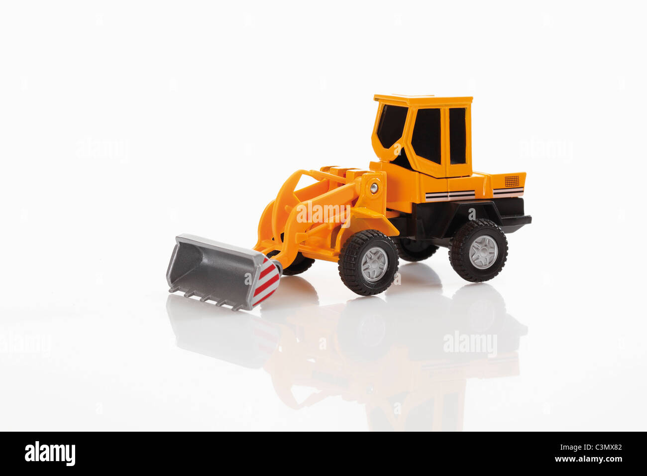 Toy bulldozer on white background Stock Photo